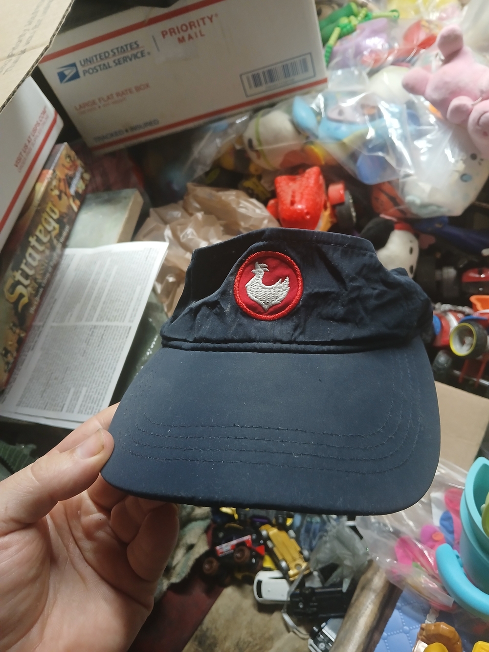 dark blue Zaxby's employee visor featuring a round red patch with a white embroi